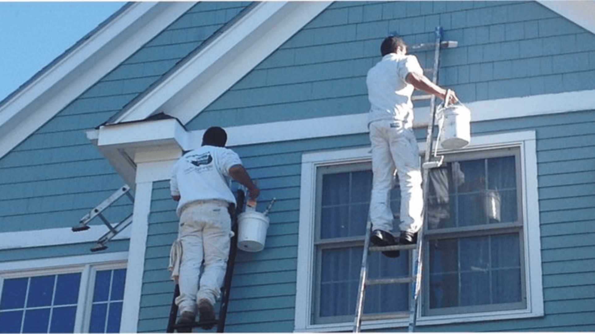 Stanford Painters painting exterior home on ladders
